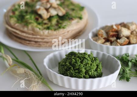 Spicy green garlic condiment, made with spring garlic, coriander leaves, green chillies and coconut oil. Shot along with indian flatbread smeared with Stock Photo