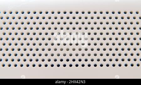 Background white plastic with round holes in the shape of a lattice, robot vacuum cleaner texture Stock Photo