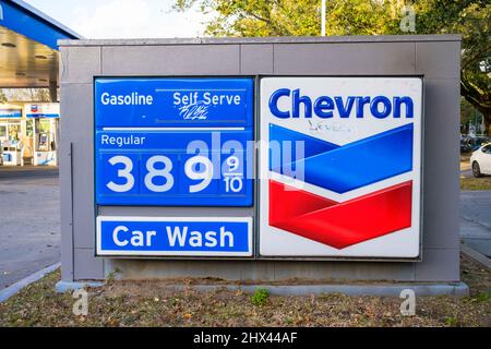 NEW ORLEANS, LA, USA - MARCH 6, 2022: Sign showing high price of regular gasoline at Chevron Gas Station in New Orleans Stock Photo