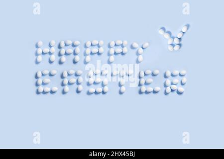 Happy Easter postcard written from  white eggs on a blue background, ideal for illustration and various use Stock Photo