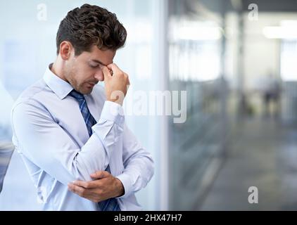 The pressure is just crazy. A young businessman looking stressed-out at the office. Stock Photo