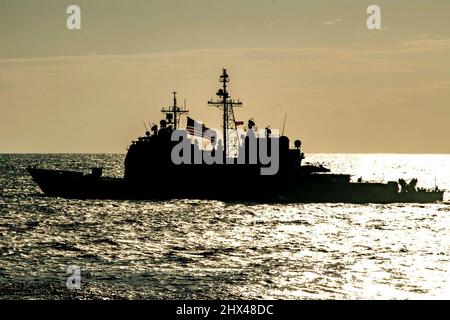 Philippine Sea. 17th Feb, 2022. The Ticonderoga-class guided-missile cruiser USS Mobile Bay (CG 53) sail in formation with Japan Maritime Self-Defense Force (JMSDF) during exercise Jungle Warfare 2022 (JWX 22). JWX 22 is a large-scale training exercise focused on leveraging the integrated capabilities of joint and allied partners to strengthen all-domain awareness, maneuver and fires across a distributed maritime environment. Credit: U.S. Navy/ZUMA Press Wire Service/ZUMAPRESS.com/Alamy Live News Stock Photo