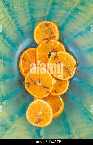 Mandarin orange slices on a blue radial pattern saucer. Product backdrop. Stock Photo