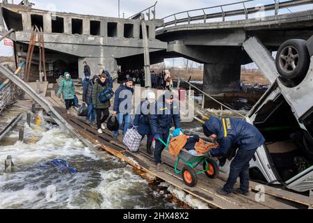 IRPIN, UKRAINE - Mar. 09, 2022: War in Ukraine. Thousands of residents of Irpin have to abandon their homes and evacuate as russian troops are bombing a peaceful city. War refugees in Ukraine Stock Photo