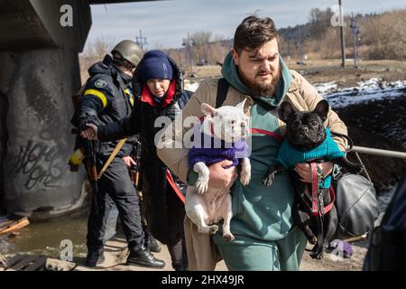 IRPIN, UKRAINE - Mar. 09, 2022: War in Ukraine. Thousands of residents of Irpin have to abandon their homes and evacuate as russian troops are bombing a peaceful city. War refugees in Ukraine Stock Photo