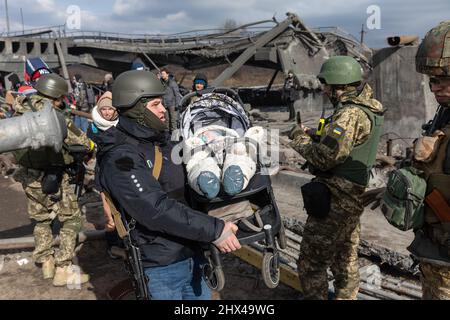 IRPIN, UKRAINE - Mar. 09, 2022: War in Ukraine. Thousands of residents of Irpin have to abandon their homes and evacuate as russian troops are bombing a peaceful city. War refugees in Ukraine Stock Photo