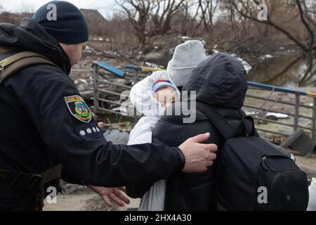 IRPIN, UKRAINE - Mar. 09, 2022: War in Ukraine. Thousands of residents of Irpin have to abandon their homes and evacuate as russian troops are bombing a peaceful city. War refugees in Ukraine Stock Photo