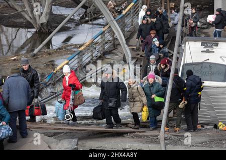 IRPIN, UKRAINE - Mar. 09, 2022: War in Ukraine. Thousands of residents of Irpin have to abandon their homes and evacuate as russian troops are bombing a peaceful city. War refugees in Ukraine Stock Photo