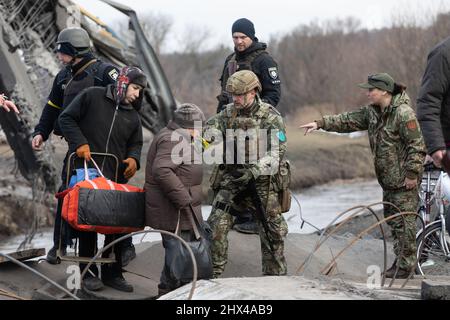 IRPIN, UKRAINE - Mar. 09, 2022: War in Ukraine. Thousands of residents of Irpin have to abandon their homes and evacuate as russian troops are bombing a peaceful city. War refugees in Ukraine Stock Photo