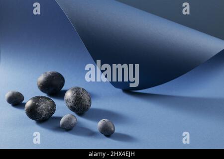 Easter eggs in a modern marble classic blue color on wooden table ...