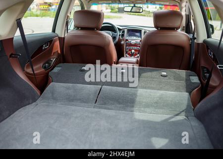 Modern black car, black SUV jeep on big wheels. Rear view of open car trunk Stock Photo