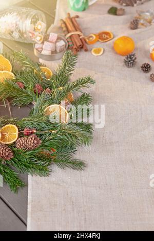 Wide banner with natural spruce wreath on a fabric tablecloth Stock Photo