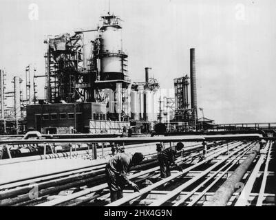 Kent's 'Cat Cracker' Completed -- A general view of Anglo-Iranian's new Kent Oil Refinery on the Isle of Grain which has now been completed and which is due to be commissioned shortly. On left is the catalytic cracker, while (right) is the distillation unit. Kent's 'cat cracker' will join those at Llandarcy and Grangemouth as a producer of highgrade motor spirit. October 13, 1953. (Photo by Planet News Ltd.). Stock Photo