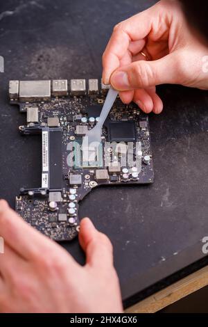 Fix or break a broken computer. Motherboard, hammer and stethoscope on ...