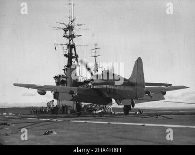 Back in Business - H.M.A.S. 'Vengeance' embarks squadron for training cruise. The first Firefly piloted by the Squadron Commander Lieutenant Commander W.G. Herbert of Elwood, Victoria. July 07, 1953. (Photo by Royal Australian Navy). Stock Photo