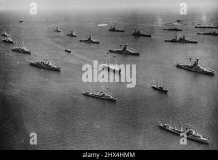 The King Reviews His Fleet At Spithead; Wonder Naval Spectacle - A magnificent aerial view of the scene as the Royal Yacht 'Victoria' And Albert' (centre) preceded by the Trinity House Yacht 'Patricia' and followed by the 'Enchantress' steamed through the lines of warships, during the great Naval Review off Spithead today, July 16. The King made his Jubilee Review of the Navy at Spithead today, July 16. July 16, 1935. (Photo by The Associated Press and Great Britain Ltd.). Stock Photo