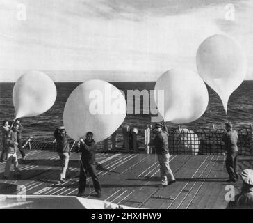 Ready To Test Cosmic Radiation -- Naval personnel aboard the icebreaker U.S.S. Staten Island, prepare to launch huge plastic balloons which will carry scientific equipment into the upper reaches for cosmic radiation tests at the north geomagnetic pole. The balloons carry 'deacon' rockets to an altitude of 70,000 feet at which point the rockets, carrying instruments, are launched from the balloons. The project is known as 'mushrat' and is sponsored by the office of Naval Research. August 25, 1953. (Photo by AP Wirephoto). Stock Photo