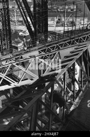 Like Busy spiders in a Huge steel web, the team of painters on the bridge climb Nonchalantly about as they work. February 01, 1951. Stock Photo