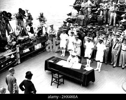Surrender In Tokyo Bay -- Admiral ***** Bruce Fraser with line up Allied Nations Signatories behind him and signs the surrender document on behalf of the United Kingdom. The ceremony took place on board Admiral Chester Nimitz's Flagship, U.S.S. Missouri in Tokyo Bay. September 10, 1945. (Photo by Australian Official Photo). Stock Photo