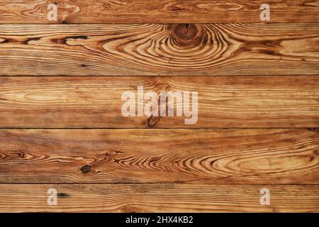 Wood plank texture for background. Burnt brown wood backdrop. Stock Photo