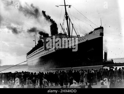 'Queen Mary' Sails On First Voyage Of Season After Overhaul -- 'Queen Mary' leaving Southampton. The 'Queen Mary' sailed from Southampton for New York on her first voyage of the season after her extensive overhaul in dry-dock. February 17, 1937. Stock Photo