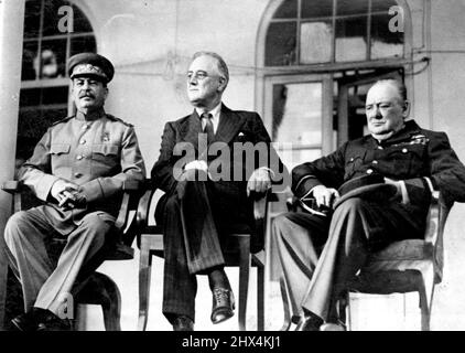 Allied Leaders Confer In Teheran -- Marshal Josef Stalin, President Franklin D. Roosevelt and Prime Minister Winston Churchill are shown on the port 100 of the Russian Embassy, at Teheran, following their historic conferences. His tunic while Prime Minister Churchill is in the uniform of a RAF Air Marshall. May 12, 1943. (Photo by ACME). Stock Photo
