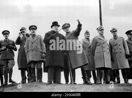 Prime Minister At Tank Demonstration -- The Prime Minister recently witnessed a tank demonstration in which he was shown the capabilities of various armoured fighting vehicles over rough country. With him were General de Gaulle, (G.O.C. Free French Forces). The Prime Minister watches the 'battle' from a hilltop. On left is General de Gaulle and on right, General Sikorski. April 18, 1941. (Photo by British Official Photograph). Stock Photo