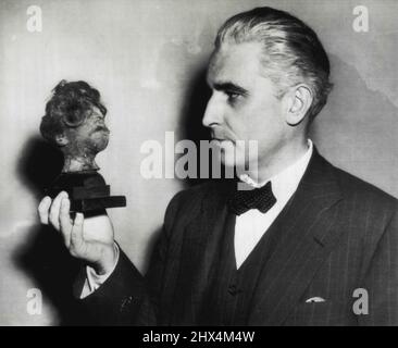 Evidence In War Crimes Trial -- Thomas Dodd, an assistant prosecuting attorney for the U.S. at the Nurenberg, Germany, War crimes trial, holds a human shrunken head he introduced as evidence of cruelty in German concentration camps. December 20, 1945. (Photo by AP Wirephoto). Stock Photo