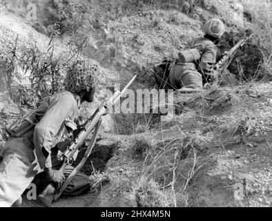 On To Rangoon Men of the 14th Army crawl up a nullah prior to bayoneting the Japs from a hill position 4 miles south of Pyawbwe. Troops of the 14th Army hurling the Jap back in an all out drive towards Rangoon shattered an enemy stand at Pyawbwe, 22 miles south east of Meiktila, Burma. More than 1,100 Japanese were killed and a number of tanks, guns and ammunition dumps destroyed in this headquarters and concentration point of enemy escaping from the North. April 01, 1945. (Photo by British Official Picture). Stock Photo