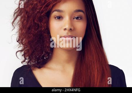 Whatever the hairstyle - she always look good. A beautful woman with sleek hair on the one side, and messy on the other. Stock Photo