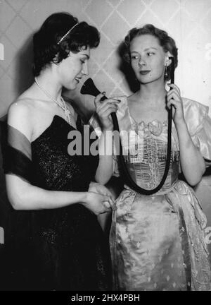 Fashionable Hearing - The old You Know - the New You Cannot See. Hazel Innes, on the right shows an Edwardian type of hearing aid to Gillian Davis, who is in fact wearing a modern hearing aid which is incorporated in the Pearl Necklace she is wearing, the main 'Michrophone' part being in the Cluster of Pearls in the front of the Necklace.A Unique Fashion show was held in London today, ***** the latest trends in ***** Hearing Aids.Among those ***** were models ***** ties, Scarved and ***** for men and in ear-rings, ***** scarf clasps, Hair-bands and Necklaces for women. May 10, 1955. (Photo by