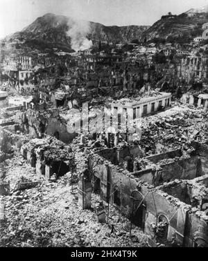 Graveyard Of A Greek City -- Not a living thing is visible amid the rubbled buildings of Zakinthos,one of the Greek island communities destroyed in last week's series of earthquakes. Smoke still rises from a-burning building in this low-level air view by Associated Press staff photographer Eddie Worth. Naval ships of five nations were pouring in tons of emergency supplies for hungry and homeless survivors today as new tremors shook the devastated islands of Kefallinia, Ithaca and Zakinthos. August 17, 1953. (Photo by Eddie Worth, AP Wirephoto). Stock Photo