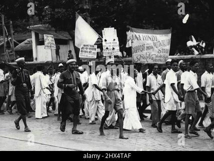 Postal Strike in Bombay -- Postal employees on strike, kept in line and shepherded by policemen, who are seen carrying umbrellas, marching through a street in Bombay with placards proclaiming their demands, on July 15.Three hundred strikes arising out of industrial disputes have taken place in Bombay this year. Ten strikes are at present in progress, including the stoppage of postal and telegraph workers, and two more are pending.The postal workers struck on July 11 seeking an increase in wages of about 20%, and the strike is still in progress. July 24, 1946. (Photo by Associated Press Photo). Stock Photo