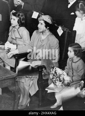 The Queen Attends Children's concert. Celebrating the coronation, a series of concerts for children are being held at London, York and Coventry. H.M. The Queen, accompanied by the Princess Elizabeth and Princess Margaret Rose, attended the Robert Mayer's Invitation coronation concert, conducted by Dr. Malcolm Sarjent, at the central hall, Westminster, London. Studies in concentration. H.M. The Queen with the little Princess keenly interested in the performance. April 6, 1937. (Photo by Sports & General Press Agency Limited) Stock Photo