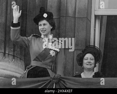 Queens At Palace After Trooping - The Queen waves from the balcony of Buckingham palace to watching crowds below, as with the Queen Mother she appeared on the balcony prior to the Royal Air force fly past which followed the Trooping the Colour ceremony. The Trooping and fly past marks the Queen's official birthday. June 5, 1952. Stock Photo