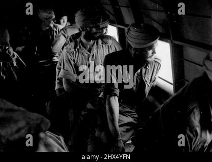 Sikhs Rescued From Japanese - Australian airmen bring Sikhs liberated when American troops attacked the Admiralty Is., to an Australian base in New Guinea. These are the first British troops captured at Singapore to be liberated. March 15, 1944. Stock Photo