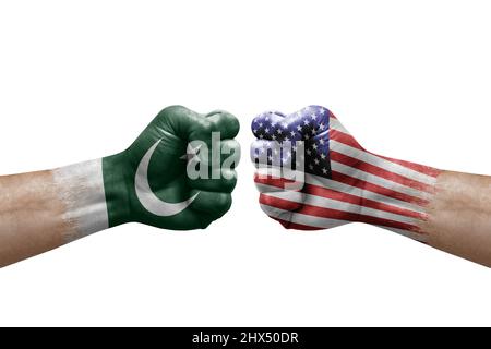 Two hands punch to each others on white background. Country flags painted fists, conflict crisis concept between pakistan and usa Stock Photo