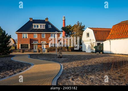 Huisduinen, North Holland, The Netherlands, 05.03.2022, View of red Lighthouse known locally as Lange Jaap from the residential area of Huisduinen Stock Photo