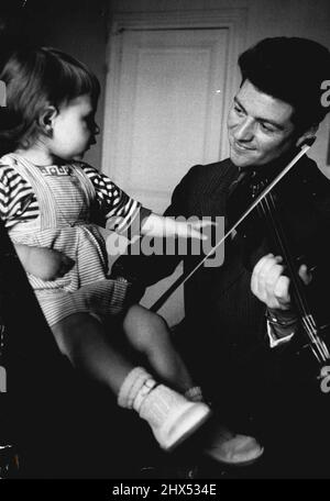 French violinist Devy Erlih, due to appear in Australia this month, plays for his daughter. June 01, 1955. (Photo by Maurice Werner Concerts Office). Stock Photo