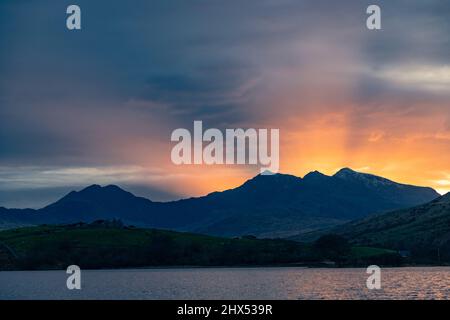 Snowdon mountain with sunbeams at sunset, Snowdonia, North Wales Stock Photo