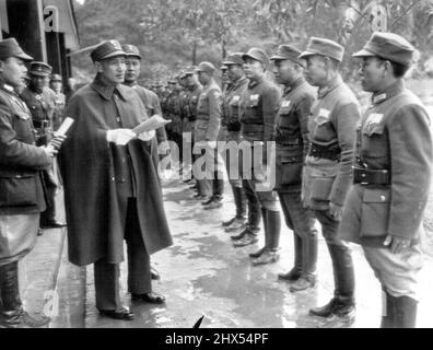 The Generalissimo Addresses His Troops - China's Generalissimo Chiang Kai-Shek (wearing cape) addresses some of his troops during visit last month to Kwangsi province where Chinese soldiers are being trained under American direction. March 27, 1944. (Photo by AP Wirephoto). Stock Photo