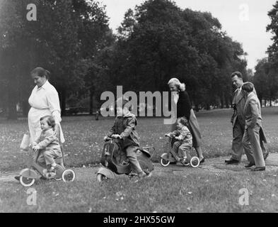 An Outing For The Rossellini Family - The Rossellini family want for an outing in London yesterday .... without Mamma, Ingrid Bergman (she stayed behind at her hotel) without Papa, Roberto Rossellini (he is still on the Continent); but with an escort of three - Italian nanny, Swiss governess, and interpreter.The children, the nanny, the governess, and the interpreter left the hotel in the Rossellinis' Rolls-Royce. And two tricycles and one bicycle went into the Rolls as well.Destination: London's Hyde Park. And here they are in the park together. October 5, 1954. (Photo by Daily Express Pictur Stock Photo