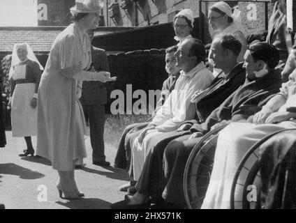 The Queen talking to wounded French soldiers in their English Hospital today, June 6. The Queen chats to wounded 'Poilus' in an English Hospital Today. The Queen today, June 6, visited a ministry of Health Emergency Hospital in the home counties where British and French soldiers of the allied armies are recovering from their wounds. July 01, 1940. (Photo by Associated Press Photo). Stock Photo