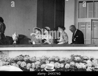 The Queens Picks A Winner - Queen Elizabeth points out her choice for the gold cup at ascot today to Queen Elizabeth the Queen Mother (left) and the Princess Royal. The gold cup, seen at left, was won by the Italian Horse, Botticelli, owned by the Marchese Incisa Della Rocchetta. July 13, 1955. (Photo by Paul Popper, Paul Popper Ltd.). Stock Photo