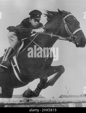 Crown Prince Akihito, 18-year-old son of Japanese Emperor Hirohito, gives a display of horsemanship as he rides his pet horse 'Wakazakura' over an obstacle in Tokyo. This picture was taken by photographer of the Japanese Imperial household. December 31, 1951. (Photo by AP Wirephoto). Stock Photo