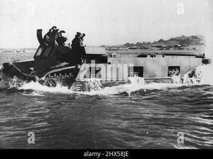 The Neptune Amphibious Tank -- 'Neptune' putting out to sea. This British tracked amphibious vehicle is a ship-to-shore load carrier capable of self-propulsion in any sea, able to land on a beach through heavy surf, and to move across country. 'Neptune' can take a pay load of approx; four tons and has a large unobstructed hold, which makes it particularly suited for the carriage of a wide variety of equipment, including the 17-pounder anti-tank and 25 pounder filed guns, vehicles, casulaties, and stores. 'Neptune' is equipped with navigation lights in addition to normal road lamps, a wireless Stock Photo