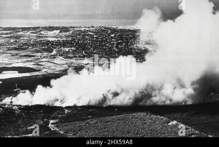 Forest Fire Rages On Island -- A giant plume of smoke drifts skyward as a brush and forest fire races through woodland on this resort island. It threatened the airport and burned over several square miles before it was brought under control. Town of Nantucket shows in background. July 24, 1949. (Photo by AP Wirephoto).