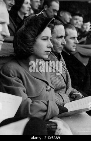 Princess Elizabeth and The Duke Of Edinburgh At Twickenham - Left to right: Princess Elizabeth with Marshal of the R.A.F., Lord Tedder and the Duke of Edinburgh watch the match from their box. H.R.H. Princess Elizabeth and the duke of Edinburgh went to Twickenham to watch the Inter-Services rugby match between the Royal Navy and the Army. The Army won 23 points to 3. March 5, 1949. Stock Photo