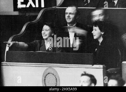 Princess Elizabeth Enjoys Herself at The Circus - Princess Elizabeth smilingly points out an amusing incident to other members of her party as she sits watching the antics of the performers in the Bertram Mills Cirous at Olympia, London, this evening (Thurs). December 30, 1948. (Photo by Reuterphoto). Stock Photo