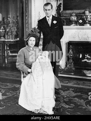 Baby Prince's Christening At Buckingham Palace : Royal mother and father with their baby son. Princess Elizabeth (holding Princess Charles) with the Duke of Edinburgh, photographed in Buckingham Palace after the christening. Prince Charles, the name by which Prince Elizabeth's son will be known to the nation, was christened Charles Philip Arthur George in a ceremony at which Dr. Fisher, Archbishop of Canterbury, officiated at Buckingham Palace, London, this afternoon (Wednesday). Prince Charles's sponsors were: the King, Queen Mary, (great-grandmother), Princess Margaret, King Haakon of Norway Stock Photo